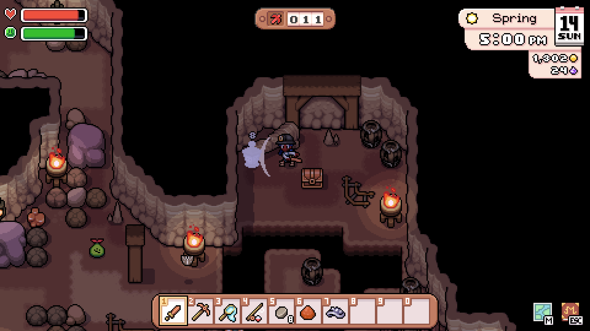 The player exploring a torch-lit mine chamber.